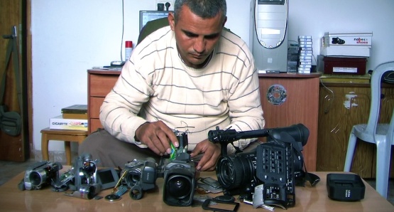 Co-director Emad Burnat with his five broken cameras. 